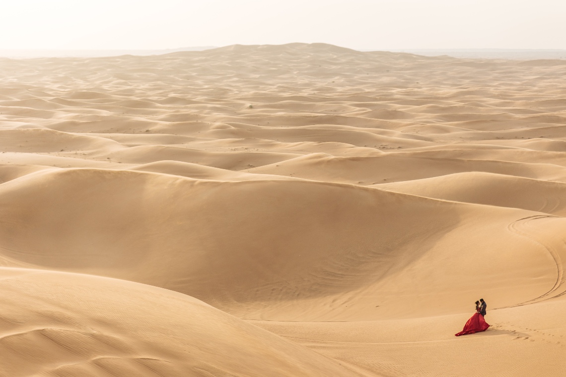 Couple in the middle of the vast Dubai Desert